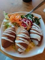 Kibbeh Bowl with Oriental Flavoured Rice Sesame Yoghurt Sauce Couscous and Pomegranate Seeds